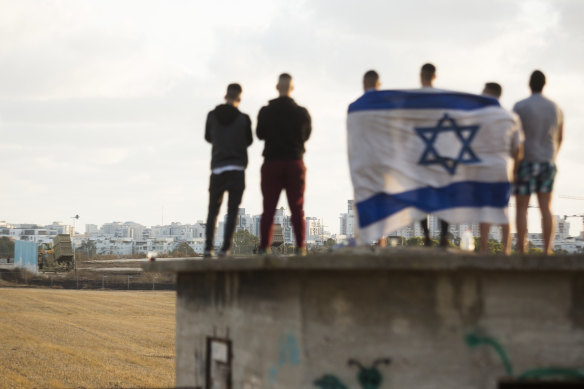 Israelis gather to watch the Iron Dome missile defence system launch to intercept rockets fire from the Gaza Strip.