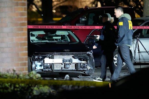 A damaged car is seen behind police tape after the Portland shooting.