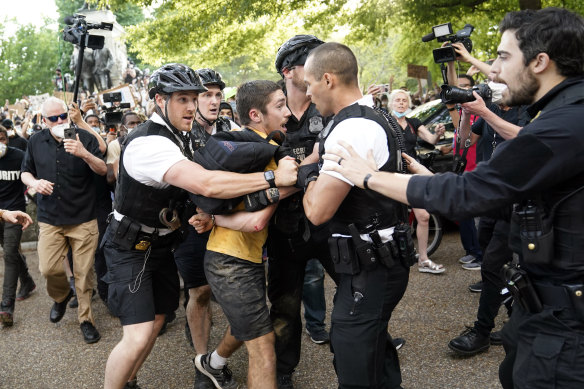 Uniformed US Secret Service police detain a protester in Lafayette Park across from the White House as demonstrators protest the death of George Floyd.