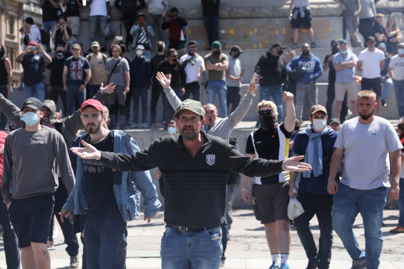 Activists from far-right linked groups chant as they face police officers in Trafalgar Square on June 13.