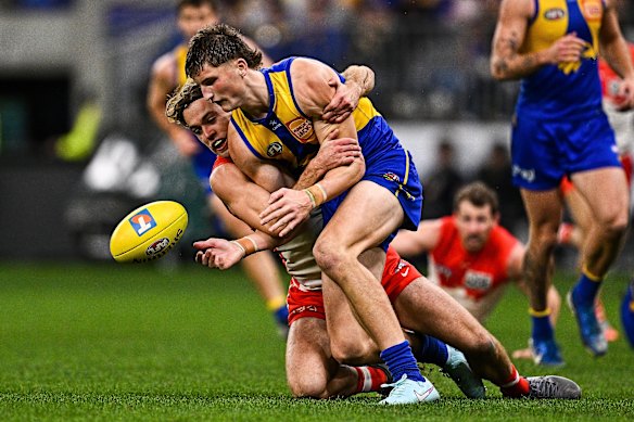 Jobe Shanahan of the Eagles is tackled by James Rowbottom of the Swans.