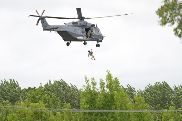 RNZAF helicopter winches a crew member down into Puketapu. 