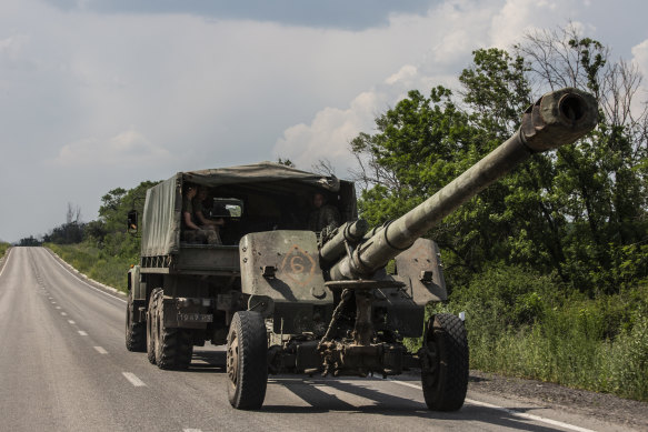 Ukrainian forces transport a 152 mm howitzer 2A65 Msta-B along a main road in the Donbas region of eastern Ukraine on June 12.