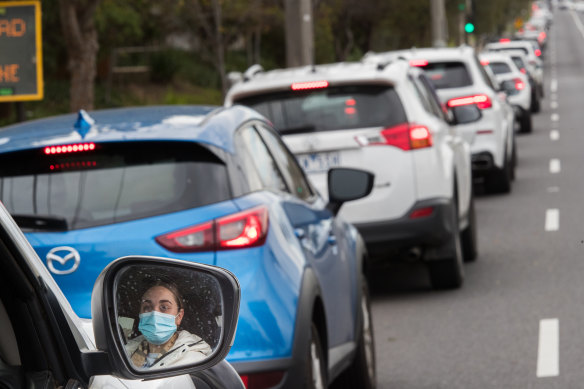 A long line of people in cars waiting for a COVID-19 test on Hampstead Road in Melbourne’s north west. 