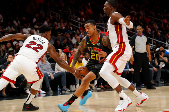 Atlanta forward John Collins (centre) has been suspended for 25 games by the NBA.