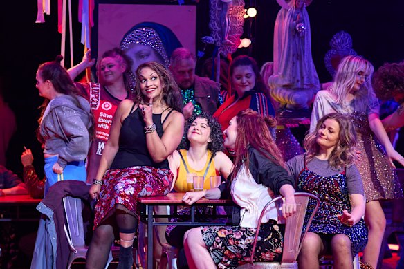 Danielle de Niese as Carmen (on table), Jane Ede as Frasquita and Helen Sherman as Mercedes.