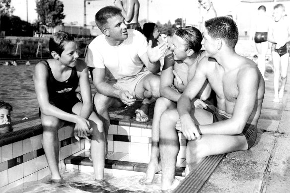 Swimming coach Don Talbot, pictured with junior stars, siblings John Konrads (right) and Ilsa Konrads (left) at Bankstown Swimming Pool, Sydney. 