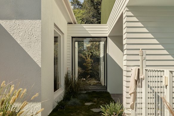 A new addition is connected via an enclosed, glazed link with courtyard-style gardens either side.