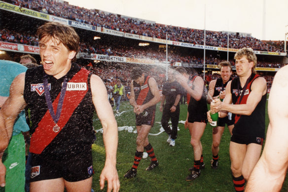 Mark Harvey sprays Mark Thompson with champagne after the 1993 grand final.
