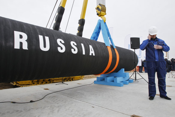 A Russian construction worker speaks on a mobile phone during a ceremony marking the start of Nord Stream pipeline construction in Portovaya Bay some 170 kms  north-west from St. Petersburg, Russia on April 9, 2010.