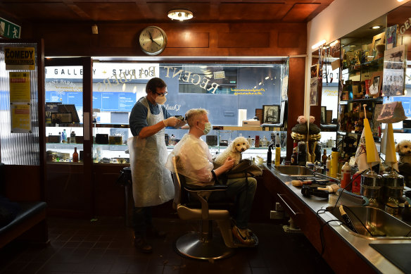 Barber Alan Kelly tends to customer Anthony Remedy at the Regents Barbers shop in Dublin, Ireland.
