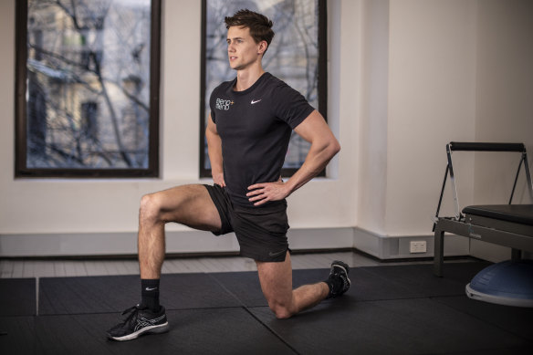 Physiotherapist Ben Wright does a hip flexor stretch.