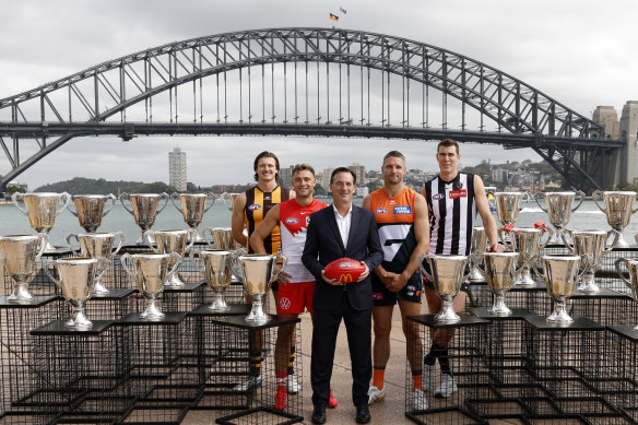 AFL boss Andrew Dillon poses for a photo with Mitch Lewis of the Hawks, Will Hayward of the Swans, Jesse Hogan of the Giants and Mason Cox of the Magpies during the 2025 AFL opening round launch in Sydney.