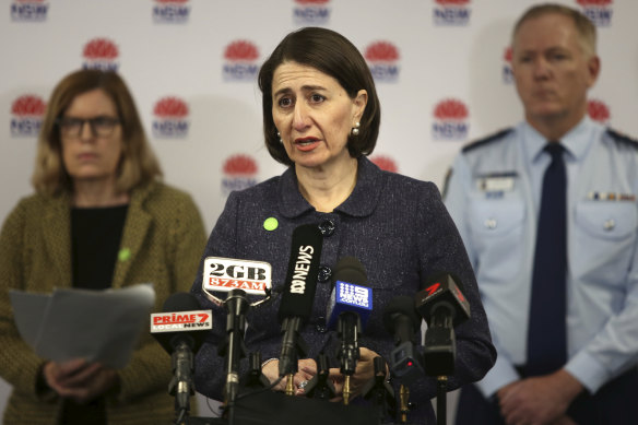 NSW Premier Gladys Berejiklian addresses the media on Wednesday flanked by Chief Health Officer Kerry Chant and Police Commissioner Mick Fuller.