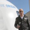 Jeff Bezos, chief executive of Amazon, with his Blue Origin New Shepard rocket.