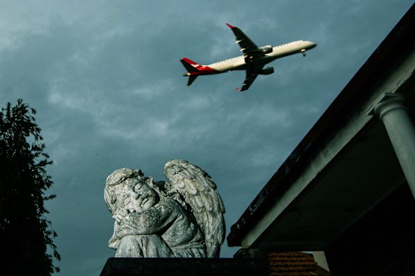 An aircraft flies above the Sydney suburb of Sydenham.