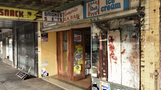 In a darkened milk bar, Nick waits for customers who will never come