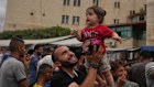 Palestinians rejoice over the peace plan outside Al-Aqsa Hospital in Gaza.