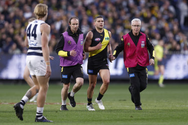Tom Stewart watches on as Dion Prestia is helped from the ground.
