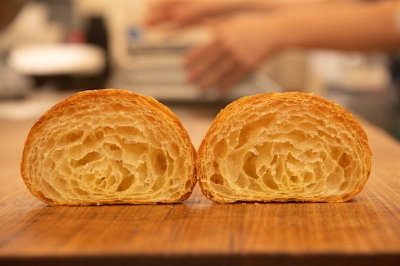 The croissant’s interior shows dozens of honeycomb-like layers.