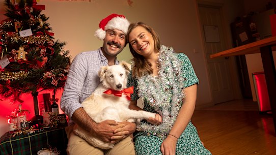 Poppy Cook, partner Ryland Mollard and dog Leila have gotten into the Christmas spirit early this year