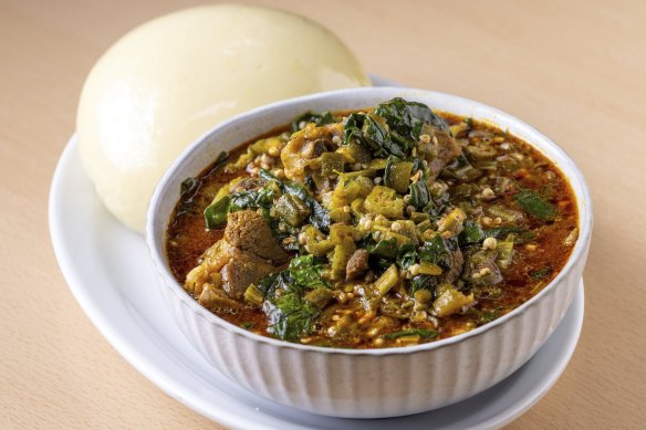 Okra and goat soup with fufu (steamed bread).