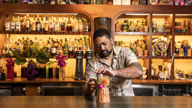 Owner Pasan Wijesena fixes a cocktail at Jacoby’s Tiki Bar.