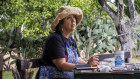Artist Wendy Sharpe on the terrace of a villa near Floridia, Sicily, where she went on a painting trip in 2022.
