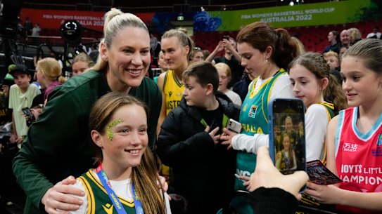 Lauren Jackson poses for a picture with a young fan at the FIBA Women’s World Cup in Sydney.
