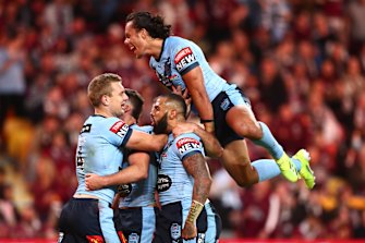 The Blues backline celebrate during game two at Suncorp Stadium.