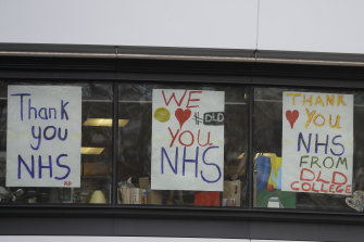 People display signs in support of the NHS in London.