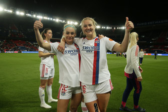 Ellie Carpenter celebrates with Lindsey Horan after Lyon’s semi-final win over PSG.
