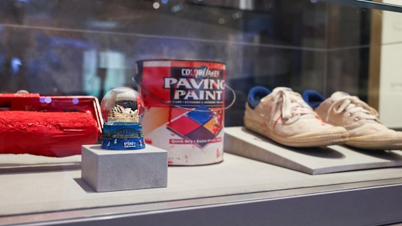 A roller, paint and shoes used by Dave Burgess and an Opera House snow globe with “No War” on display in  the Australian War Memorial in Canberra  