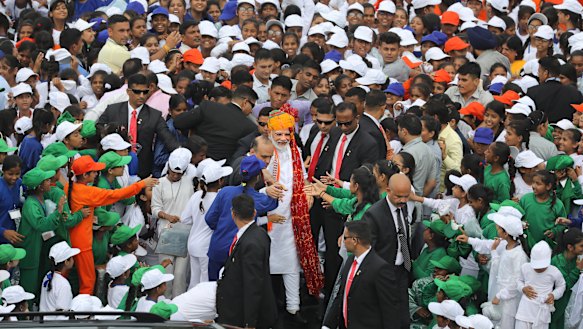 While Kashmiris are in lockdown, people in New Delhi were free to watch Prime Minister Narendra Modi (centre, wearing turban) address the nation on Independence Day.