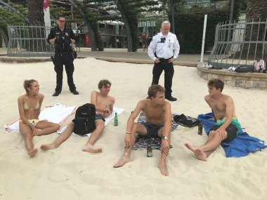 UQ students Lucia Sanchez and Caden Bencz, with US friends Alec Rioux and Trevor Raffin, meet police at South Bank in Brisbane.