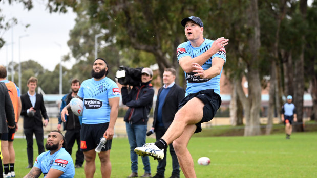 Making it rain: Matt Burton launches a ball to the heavens at NSW training.