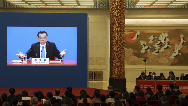 Chinese Premier Li Keqiang is displayed on a screen during a press conference after the closing session of the National People's Congress in Beijing's Great hall of the People on Friday.
