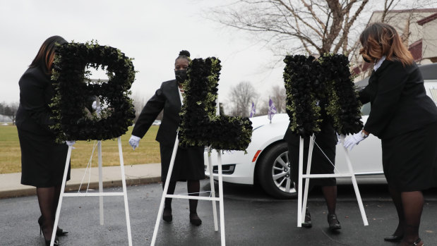 Church staff arrange flowers that speak out "BLM" before the casket of Andre Hill is brought to a hearse following his funeral in Columbos, Ohio. The 47-year-old black man, was shot and killed by a police officer in December.