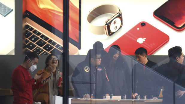 Customers at the Apple store in Beijing. The US tech giant has agreed to remove hundreds of apps to do business in the country. 