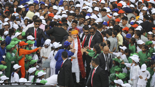 While Kashmiris are in lockdown, people in New Delhi were free to watch Prime Minister Narendra Modi (centre, wearing turban) address the nation on Independence Day.