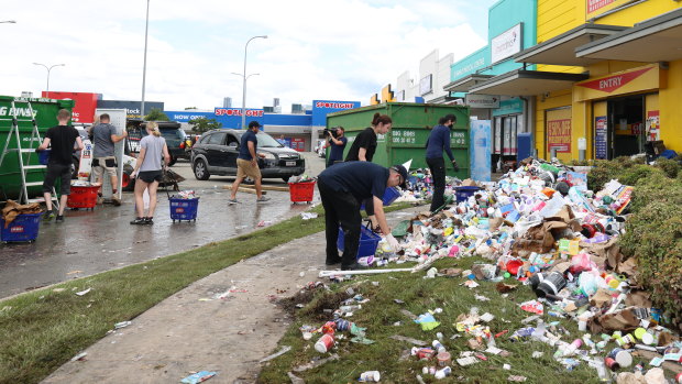 Staff work to clean up flood damage at a chemist warehouse at Windsor.