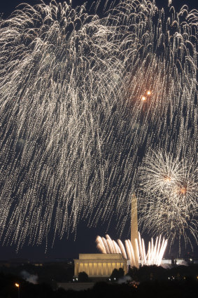 Fourth of July fireworks explode over the Lincoln Memorial, the Washington Monument and the US Capitol, along the National Mall in Washington.