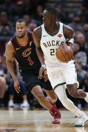 Milwaukee's Tony Snell pushes the ball past Cleveland's Rodney Hood.