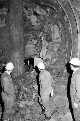 Workers inspect a hole in the tunnel linking Parliament Station to Jolimont Station.