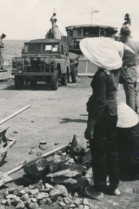 Locals watch as troops and vehicles of the 1st Battalion land on the beach at Vung Tau, Vietnam on June 8, 1965.