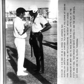 Scan from AP radiogram image in the Fairfax Archive. Bob Simpson taking with a policeman at Sabina Park, May 3, 1978.