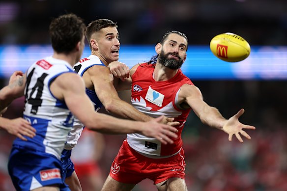 Brodie Grundy of the Swans taps the ball.