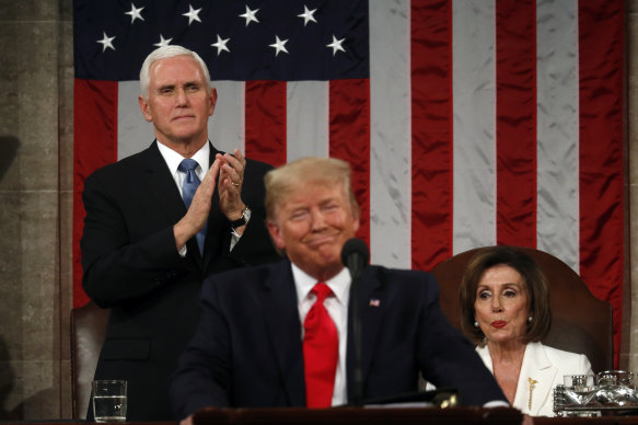 Mike Pence, left, and Nancy Pelosi listen to US President Donald Trump's State of the Union speech.