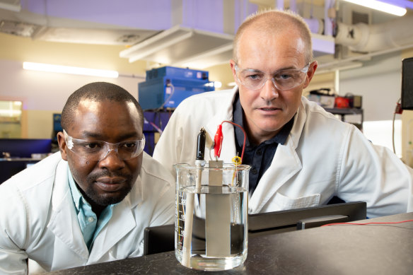 PhD researcher Olawale Oloye (left) and Professor Anthony O’Mullane have developed a method to capture carbon for use in cement.