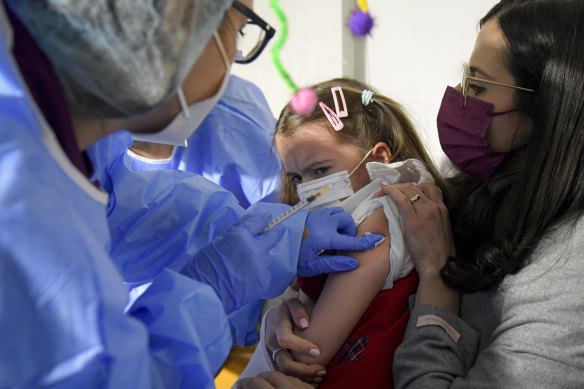 Patricia, 8, grimaces after getting her first dose of the Pfizer vaccine  in Bucharest, Romania.